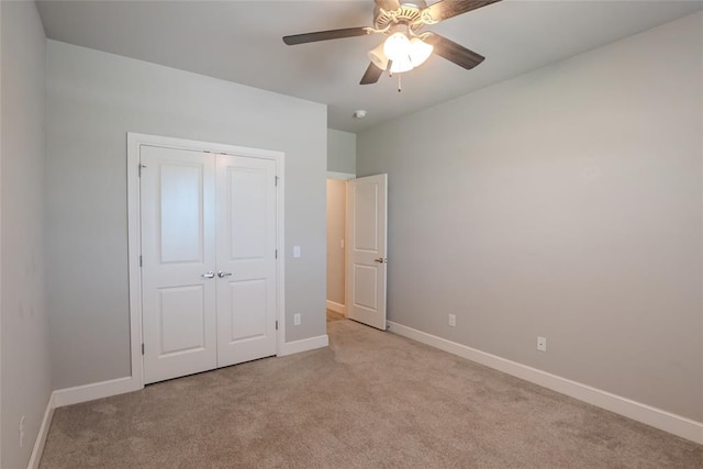 12037 Ashford Dr, Yukon, OK 73099 - unfurnished bedroom with light carpet, a closet, and ceiling fan