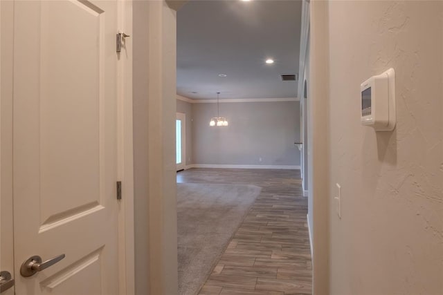 12037 Ashford Dr, Yukon, OK 73099 - corridor featuring crown molding, wood finished floors, a chandelier, and recessed lighting