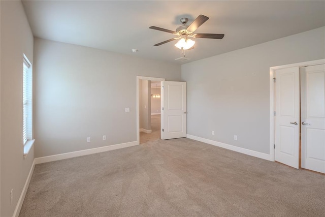 12037 Ashford Dr, Yukon, OK 73099 - unfurnished bedroom with light colored carpet, ceiling fan, and a closet