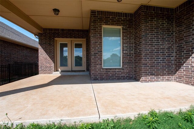 12037 Ashford Dr, Yukon, OK 73099 - view of patio / terrace featuring french doors