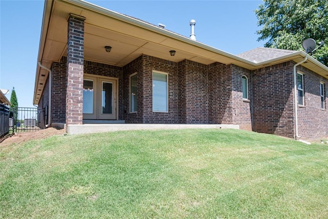12037 Ashford Dr, Yukon, OK 73099 - view of front of property featuring brick siding and french doors