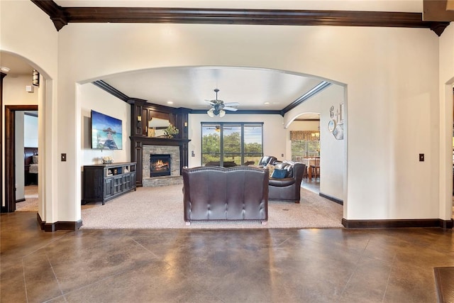 126 Castle Gate Dr, Choctaw, OK 73020 - living area featuring ornamental molding, a ceiling fan, arched walkways, concrete flooring, and a stone fireplace