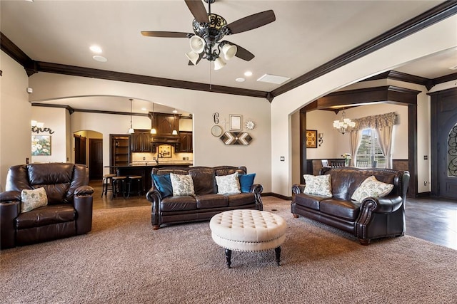 126 Castle Gate Dr, Choctaw, OK 73020 - carpeted living room featuring arched walkways, crown molding, a chandelier, a ceiling fan, and recessed lighting