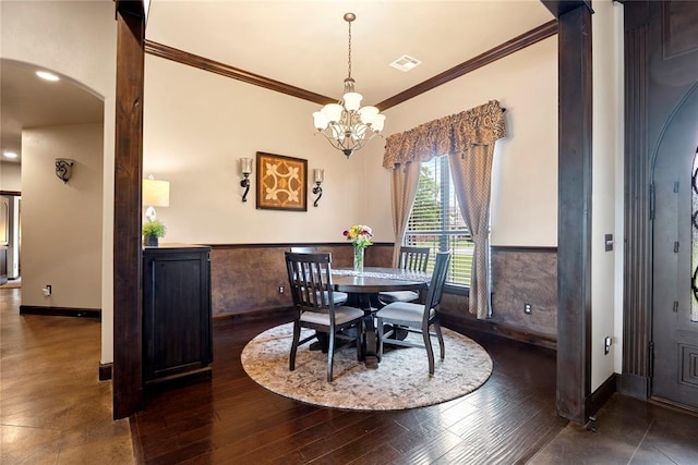 126 Castle Gate Dr, Choctaw, OK 73020 - dining area with arched walkways, crown molding, a chandelier, wood finished floors, and a wainscoted wall