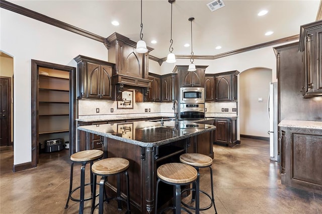 126 Castle Gate Dr, Choctaw, OK 73020 - kitchen featuring appliances with stainless steel finishes, arched walkways, finished concrete floors, dark brown cabinetry, and crown molding