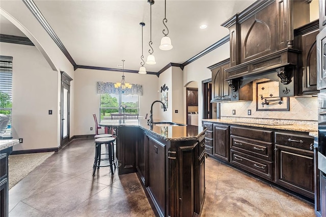 126 Castle Gate Dr, Choctaw, OK 73020 - kitchen with arched walkways, black electric stovetop, ornamental molding, backsplash, and dark brown cabinetry