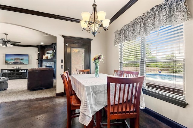 126 Castle Gate Dr, Choctaw, OK 73020 - dining area featuring ornamental molding, a chandelier, concrete floors, ceiling fan, and a fireplace