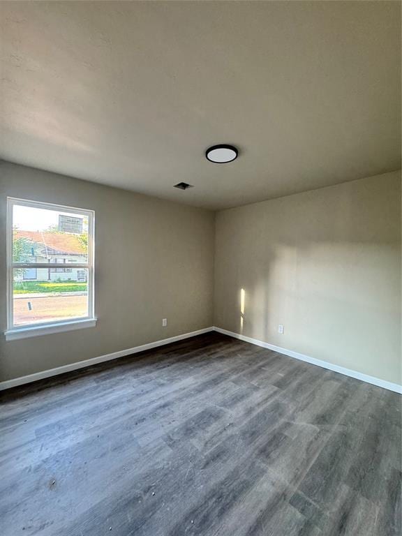 1822 N Jordan Ave, Oklahoma City, OK 73111 - unfurnished room featuring baseboards and dark wood-style flooring