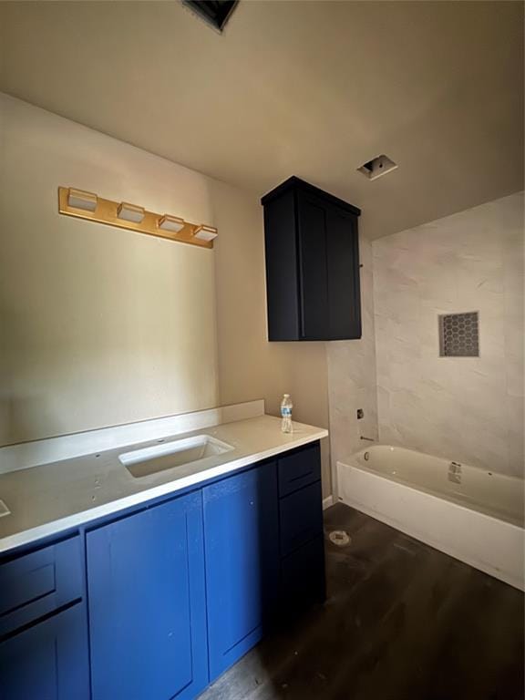 1822 N Jordan Ave, Oklahoma City, OK 73111 - bathroom featuring vanity, a tub to relax in, and wood finished floors