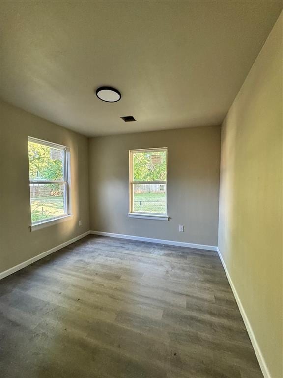 1822 N Jordan Ave, Oklahoma City, OK 73111 - unfurnished room with dark wood-style floors and baseboards