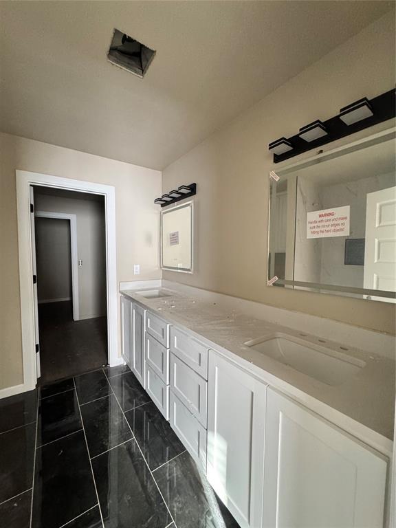 1822 N Jordan Ave, Oklahoma City, OK 73111 - bathroom featuring double vanity and marble finish flooring