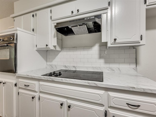 8533 SW 76th St, Oklahoma City, OK 73169 - kitchen featuring black appliances, white cabinetry, backsplash, and under cabinet range hood