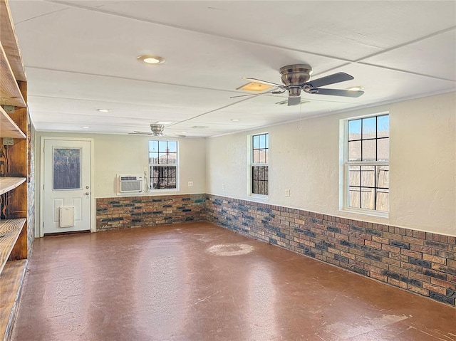 10300 Ryecroft Rd, Oklahoma City, OK 73162 - below grade area featuring ceiling fan, brick wall, a wainscoted wall, healthy amount of natural light, and a wall unit AC