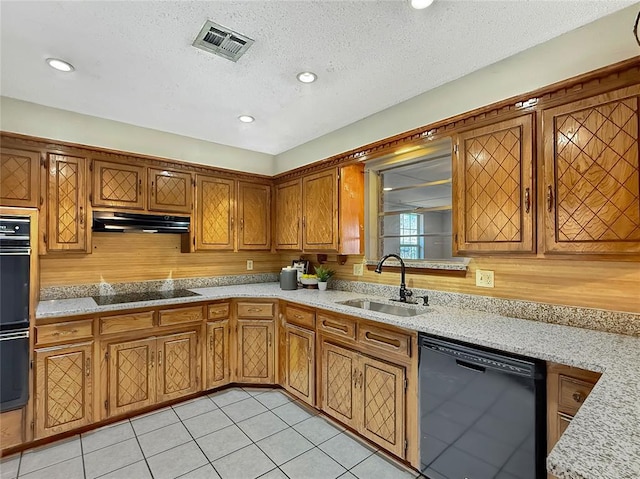 10300 Ryecroft Rd, Oklahoma City, OK 73162 - kitchen with black appliances, under cabinet range hood, light countertops, brown cabinets, and light tile patterned floors