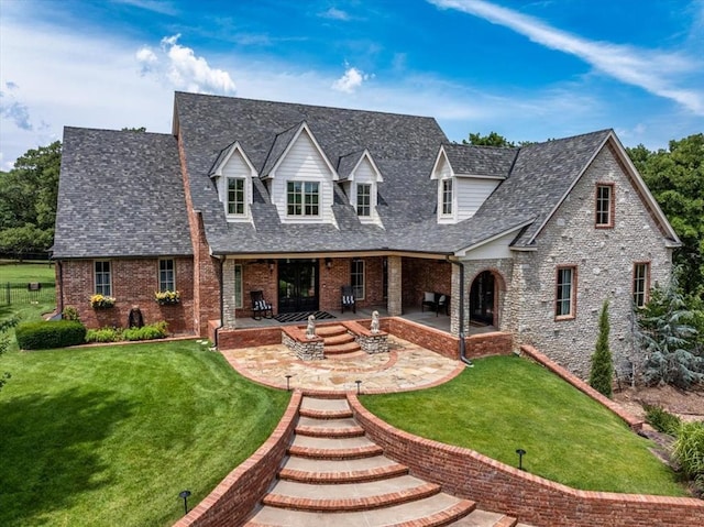 10035 Stone Gate Way, Arcadia, OK 73007 - new england style home featuring brick siding, a patio, and a front lawn
