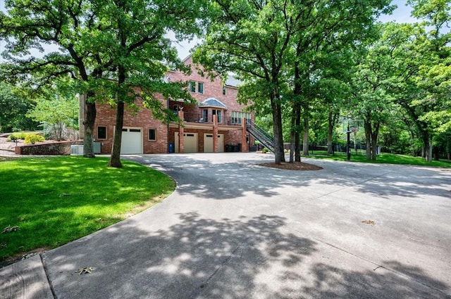 10035 Stone Gate Way, Arcadia, OK 73007 - view of front facade featuring asphalt driveway, an attached garage, brick siding, a front yard, and stairway