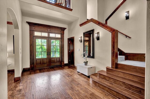 10035 Stone Gate Way, Arcadia, OK 73007 - entryway with wood finished floors, stairs, french doors, a towering ceiling, and arched walkways