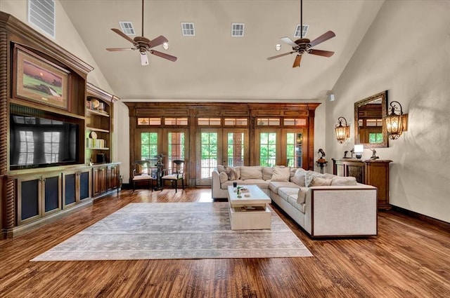 10035 Stone Gate Way, Arcadia, OK 73007 - living room featuring ceiling fan, high vaulted ceiling, french doors, and wood finished floors