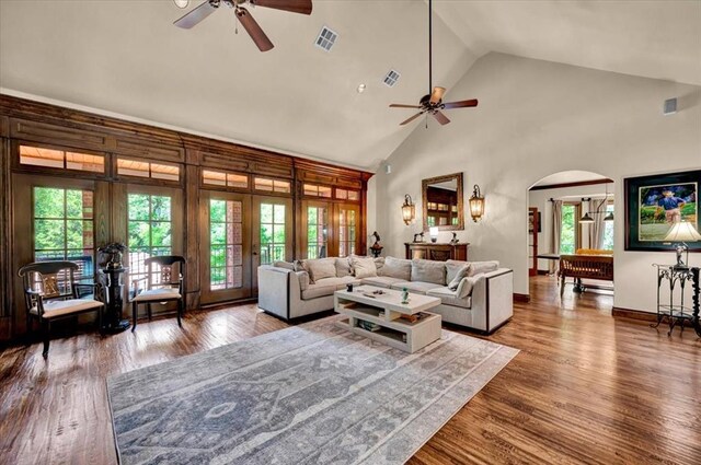 10035 Stone Gate Way, Arcadia, OK 73007 - living room featuring a ceiling fan, arched walkways, french doors, healthy amount of natural light, and high vaulted ceiling