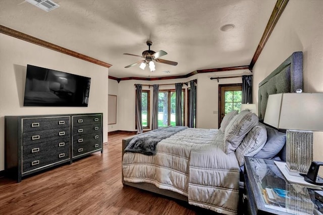 10035 Stone Gate Way, Arcadia, OK 73007 - bedroom featuring crown molding, wood finished floors, a textured ceiling, and a ceiling fan