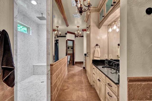 10035 Stone Gate Way, Arcadia, OK 73007 - full bathroom featuring a chandelier, a walk in shower, vanity, a textured wall, and ornamental molding