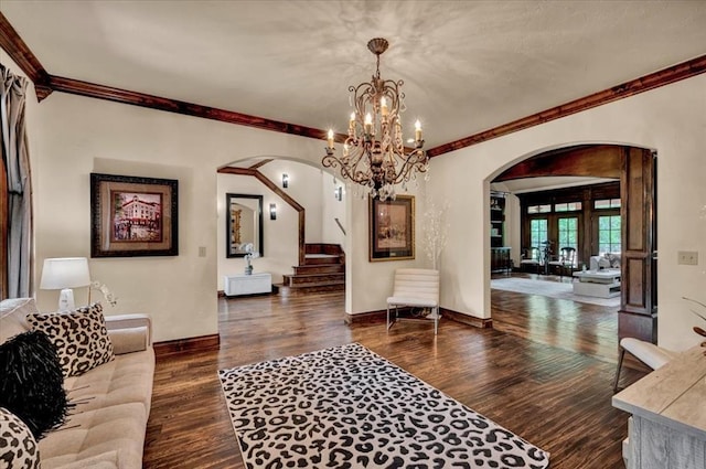 10035 Stone Gate Way, Arcadia, OK 73007 - living room featuring arched walkways, crown molding, dark wood finished floors, and a chandelier