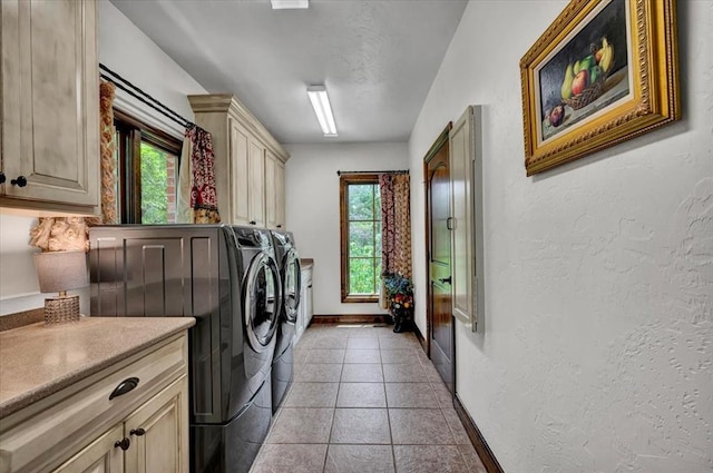 10035 Stone Gate Way, Arcadia, OK 73007 - washroom featuring washing machine and clothes dryer, cabinet space, plenty of natural light, a textured wall, and light tile patterned floors