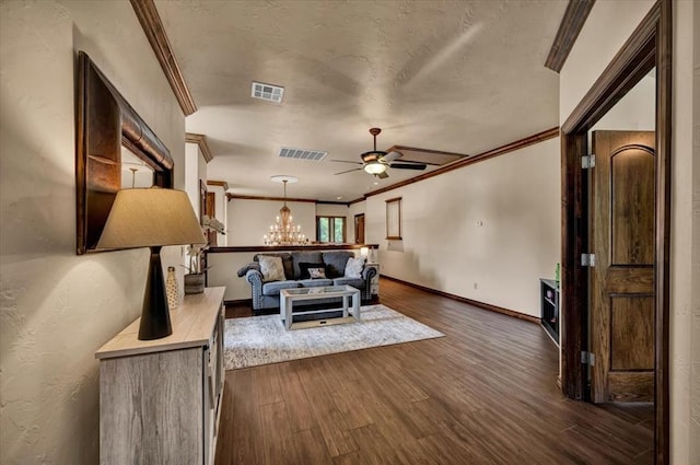 10035 Stone Gate Way, Arcadia, OK 73007 - living area featuring ornamental molding, dark wood-type flooring, ceiling fan, a chandelier, and a textured ceiling