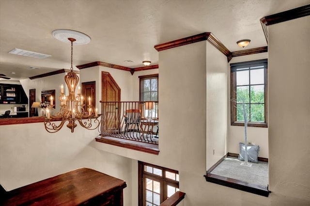 10035 Stone Gate Way, Arcadia, OK 73007 - staircase featuring ornamental molding and a chandelier