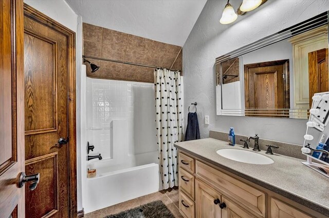 10035 Stone Gate Way, Arcadia, OK 73007 - bathroom featuring vanity, shower / bathtub combination with curtain, and a textured wall