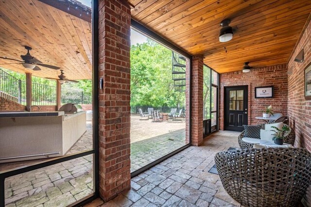 10035 Stone Gate Way, Arcadia, OK 73007 - sunroom with plenty of natural light, ceiling fan, and exterior kitchen