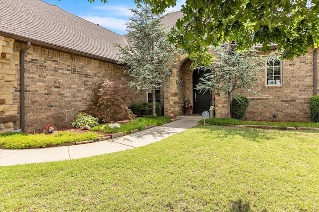 412 Swingman Rd, Yukon, OK 73099 - view of front of property with a shingled roof, a front lawn, and brick siding