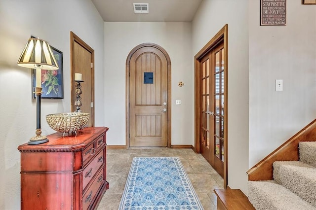 412 Swingman Rd, Yukon, OK 73099 - entrance foyer with arched walkways, stairs, and french doors