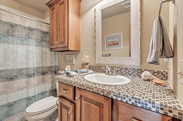 412 Swingman Rd, Yukon, OK 73099 - bathroom featuring vanity, backsplash, and curtained shower