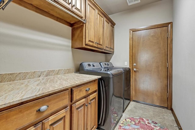 412 Swingman Rd, Yukon, OK 73099 - laundry room with independent washer and dryer, cabinet space, and light tile patterned floors