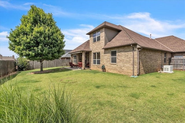 412 Swingman Rd, Yukon, OK 73099 - rear view of property featuring a fenced backyard, brick siding, a shingled roof, and a patio area