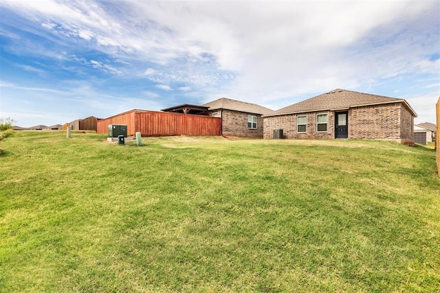 9920 Black Bear Trl, Yukon, OK 73099 - rear view of property with a yard and brick siding