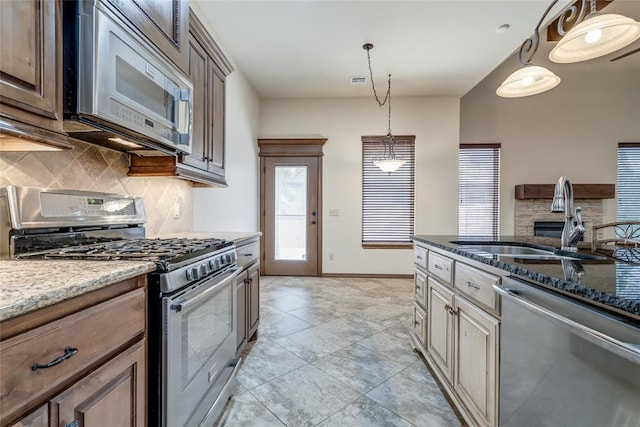 2216 SW 117th St, Oklahoma City, OK 73170 - kitchen with appliances with stainless steel finishes, tasteful backsplash, and dark stone counters