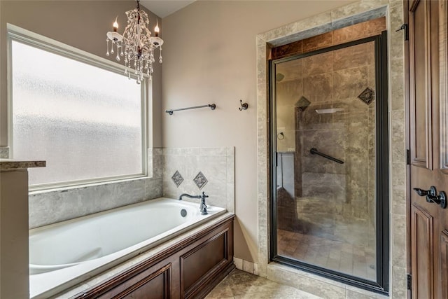 2216 SW 117th St, Oklahoma City, OK 73170 - full bathroom featuring a stall shower, a garden tub, and a chandelier