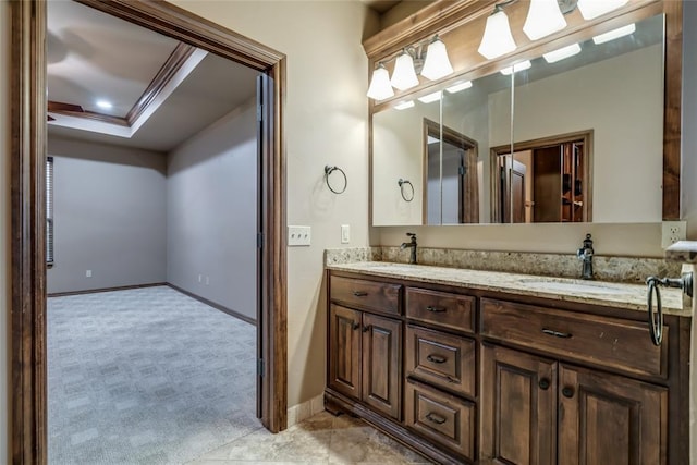 2216 SW 117th St, Oklahoma City, OK 73170 - full bathroom with double vanity, a tray ceiling, and crown molding