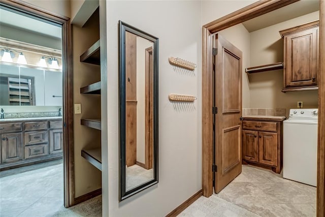 2216 SW 117th St, Oklahoma City, OK 73170 - bathroom featuring washer / clothes dryer, double vanity, and tile patterned flooring