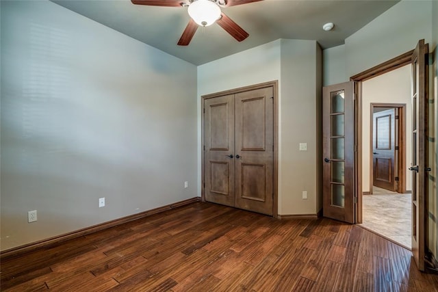 2216 SW 117th St, Oklahoma City, OK 73170 - unfurnished bedroom featuring dark wood-style floors, a ceiling fan, and a closet