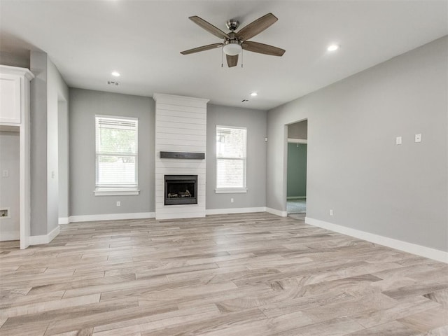 8520 NW 123rd St, Oklahoma City, OK 73142 - unfurnished living room featuring a ceiling fan, light wood-type flooring, recessed lighting, and a large fireplace