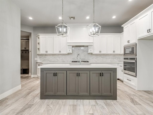 8520 NW 123rd St, Oklahoma City, OK 73142 - kitchen featuring appliances with stainless steel finishes, a chandelier, light countertops, white cabinets, and recessed lighting