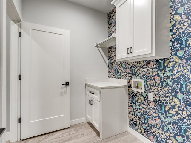 8520 NW 123rd St, Oklahoma City, OK 73142 - washroom featuring cabinet space, washer hookup, and light wood-style floors
