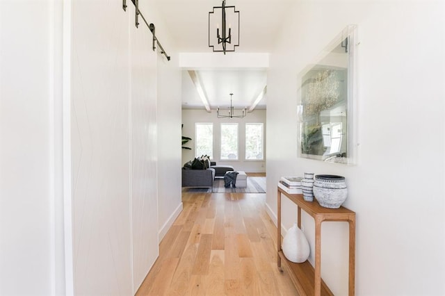 416 Old Creek Rd, Edmond, OK 73034 - corridor with a barn door, light wood-style floors, and a chandelier