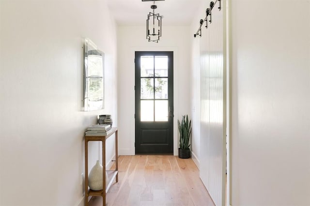 416 Old Creek Rd, Edmond, OK 73034 - doorway to outside with a barn door and light wood-style flooring