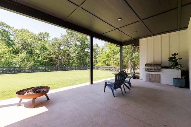 416 Old Creek Rd, Edmond, OK 73034 - fenced backyard featuring exterior kitchen, a patio area, and view of wooded area
