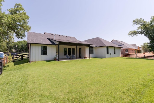 416 Old Creek Rd, Edmond, OK 73034 - back of property with board and batten siding, a fenced backyard, and roof with shingles
