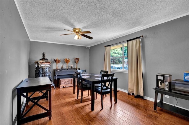 1017 Linn Ln, Yukon, OK 73099 - dining room with a textured ceiling, a ceiling fan, hardwood / wood-style flooring, and crown molding